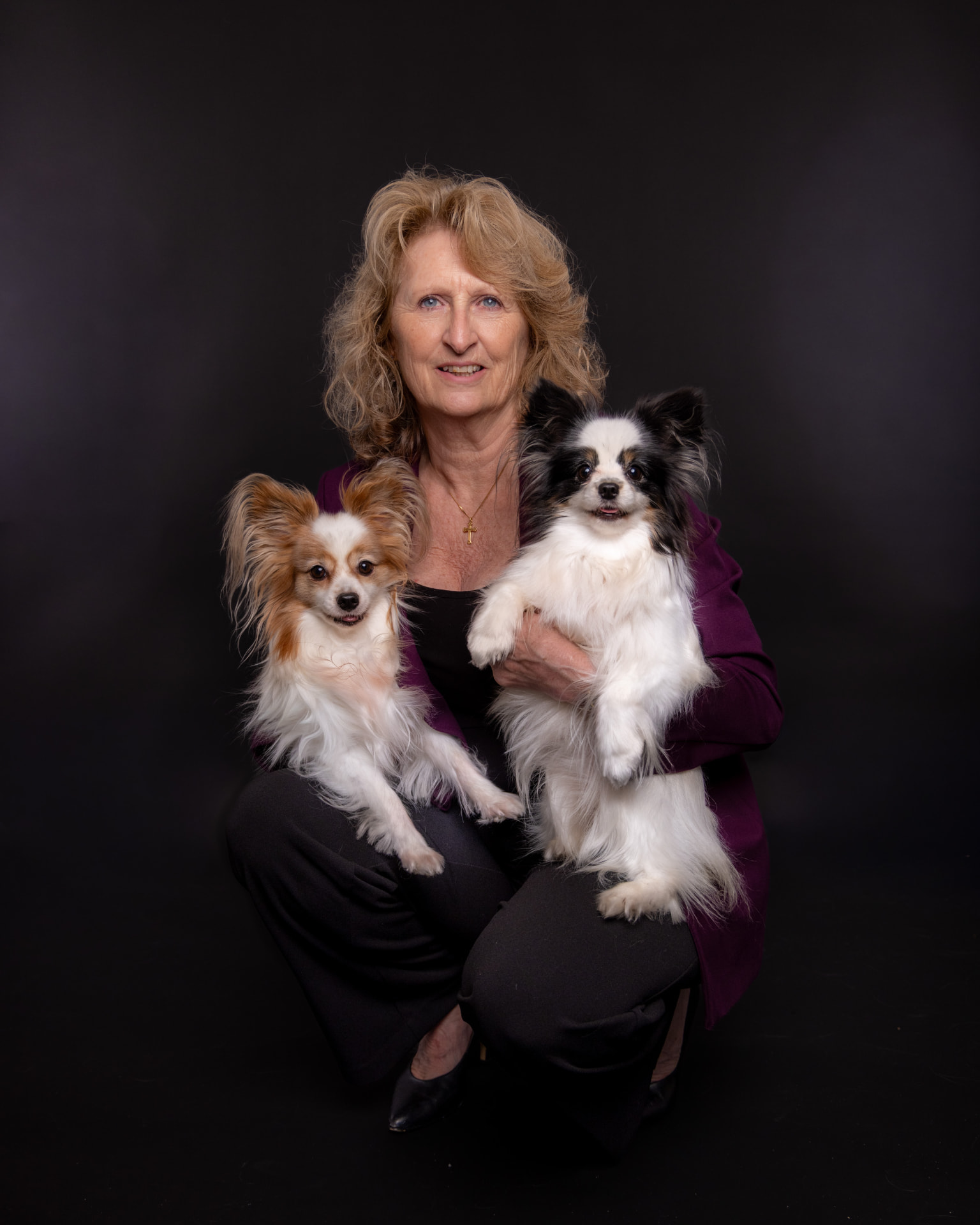 Kelly Arsenault, REALTOR®, holding her two Papillon dogs